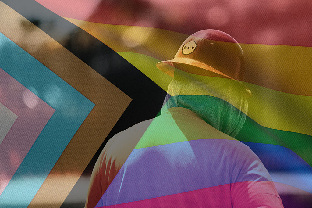 Construction worker from behind with pride flag overlay.