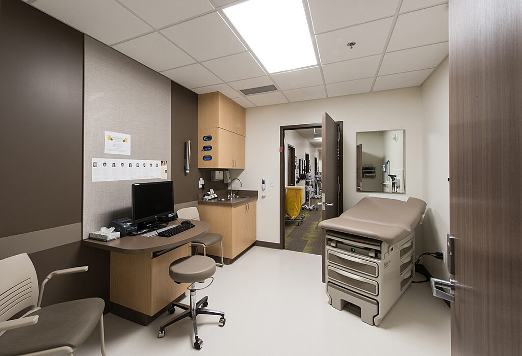 patient care room at Issaquah clinic with patient exam table and nurse computer and supply cabinet