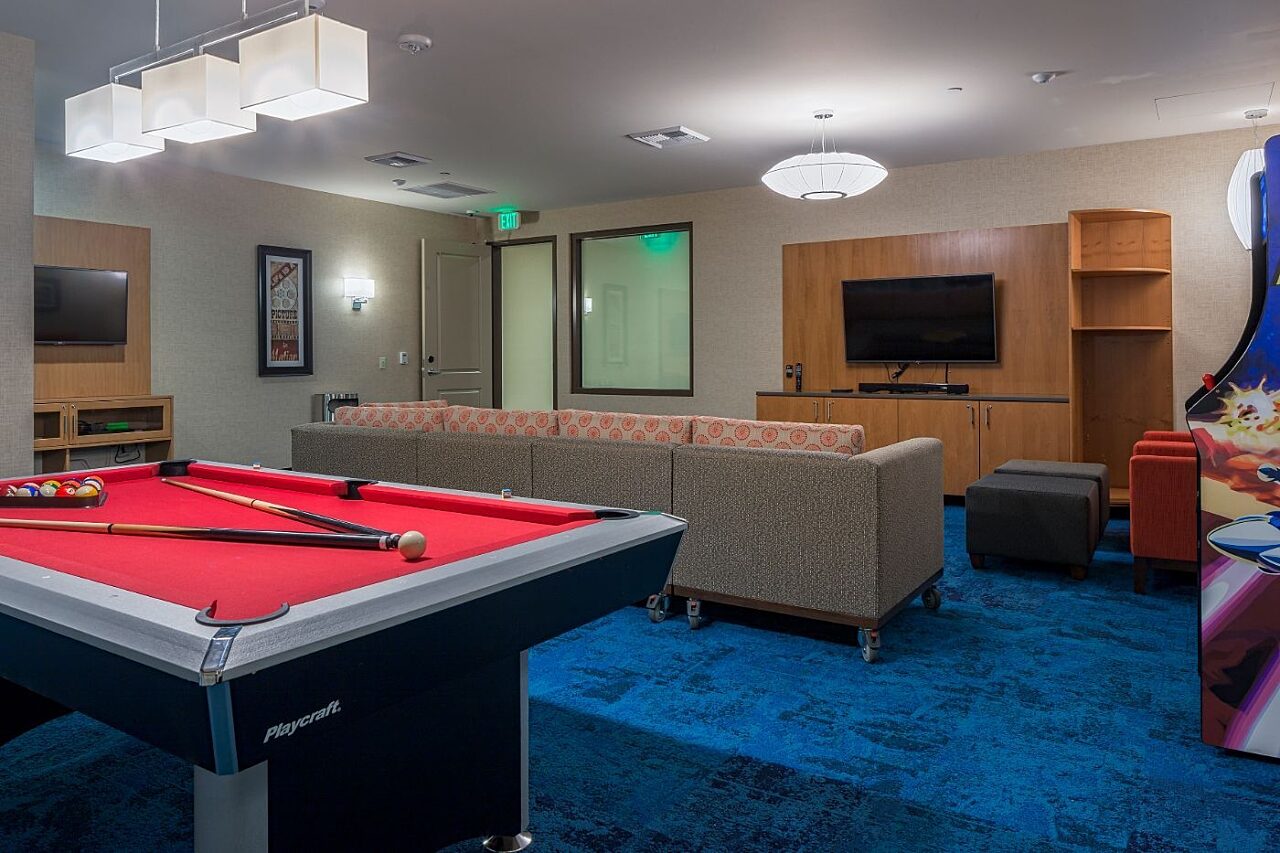 Media and lounge room with pool table at Homewood Suites by Hilton