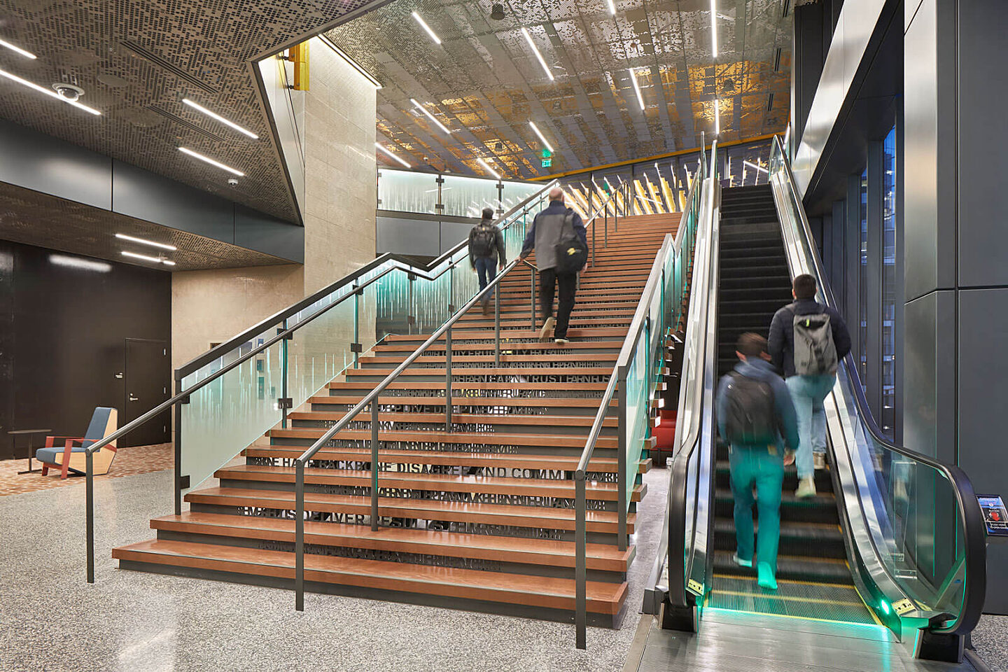 People walking down stairs inside of Amazon Block 21