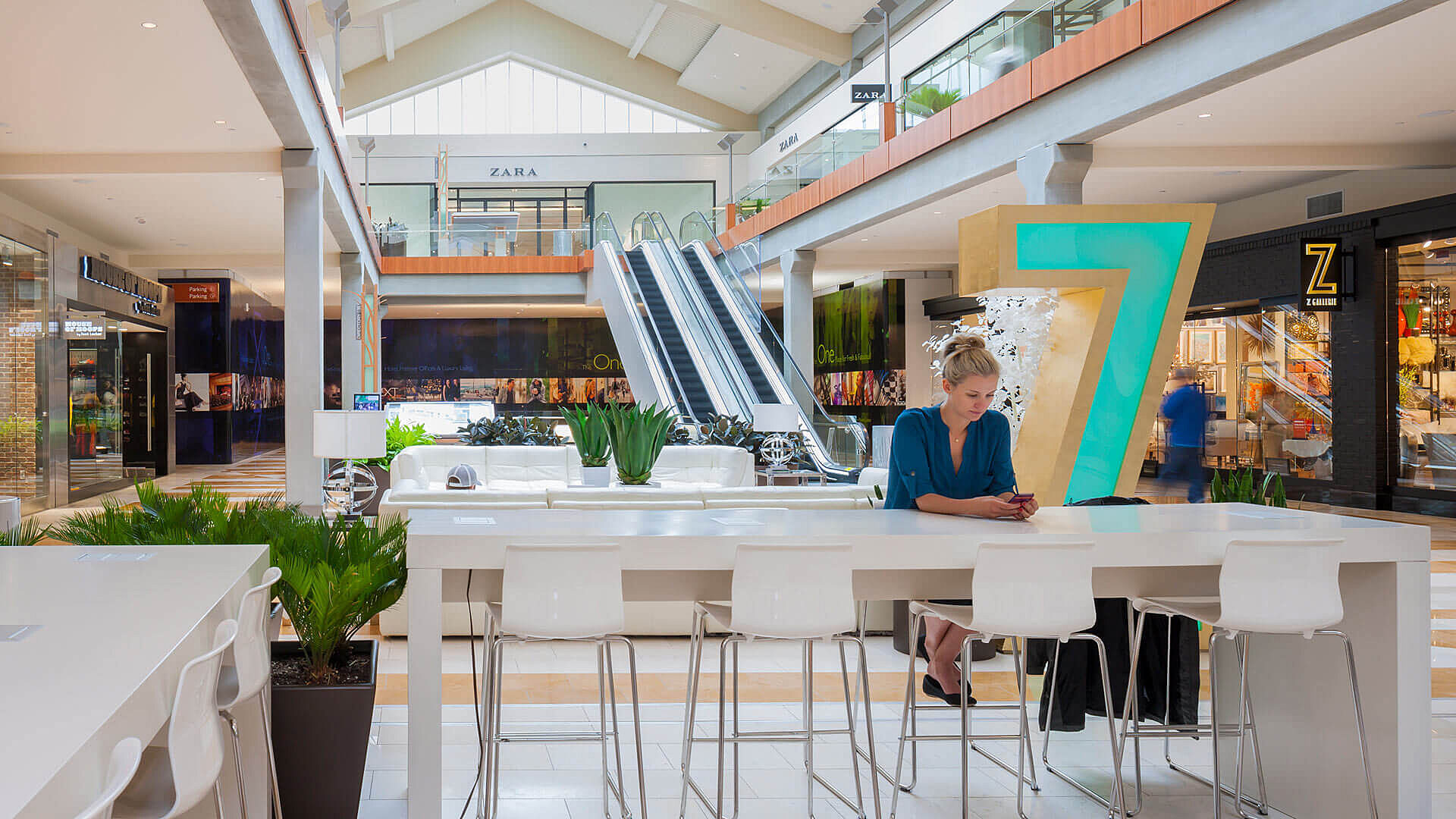 Woman on her phone at Bellevue Square South Common Shops