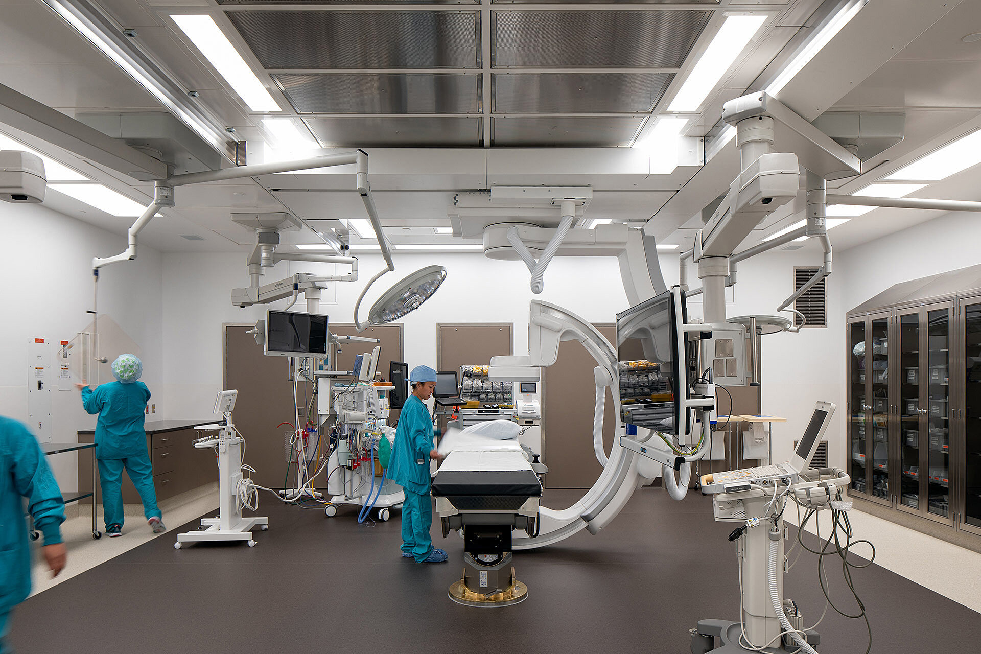 Interior photo of high-tech surgery room with doctors and nurses working