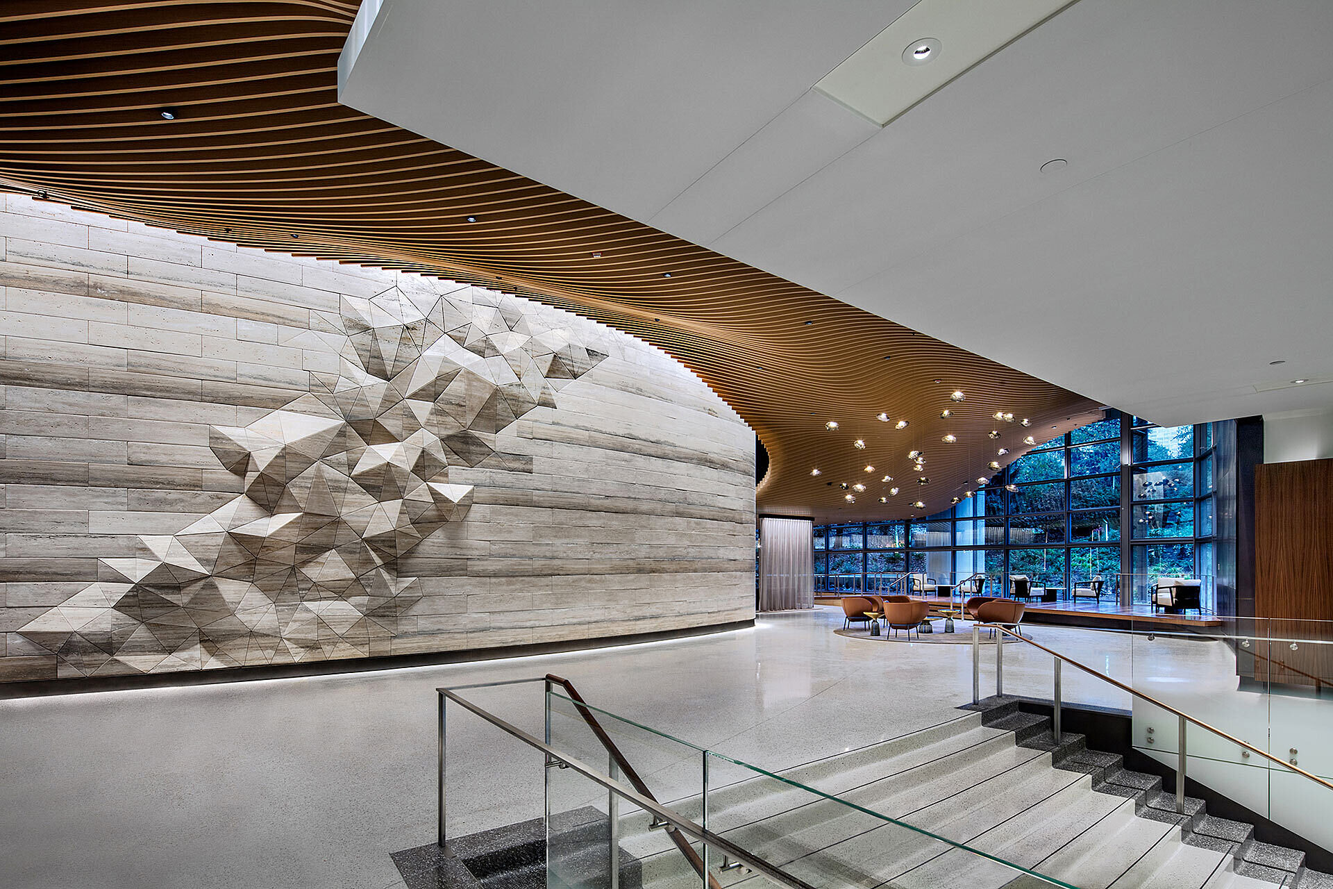 Interior of office building common area showing wall with 3D geographic rendition of mountain range