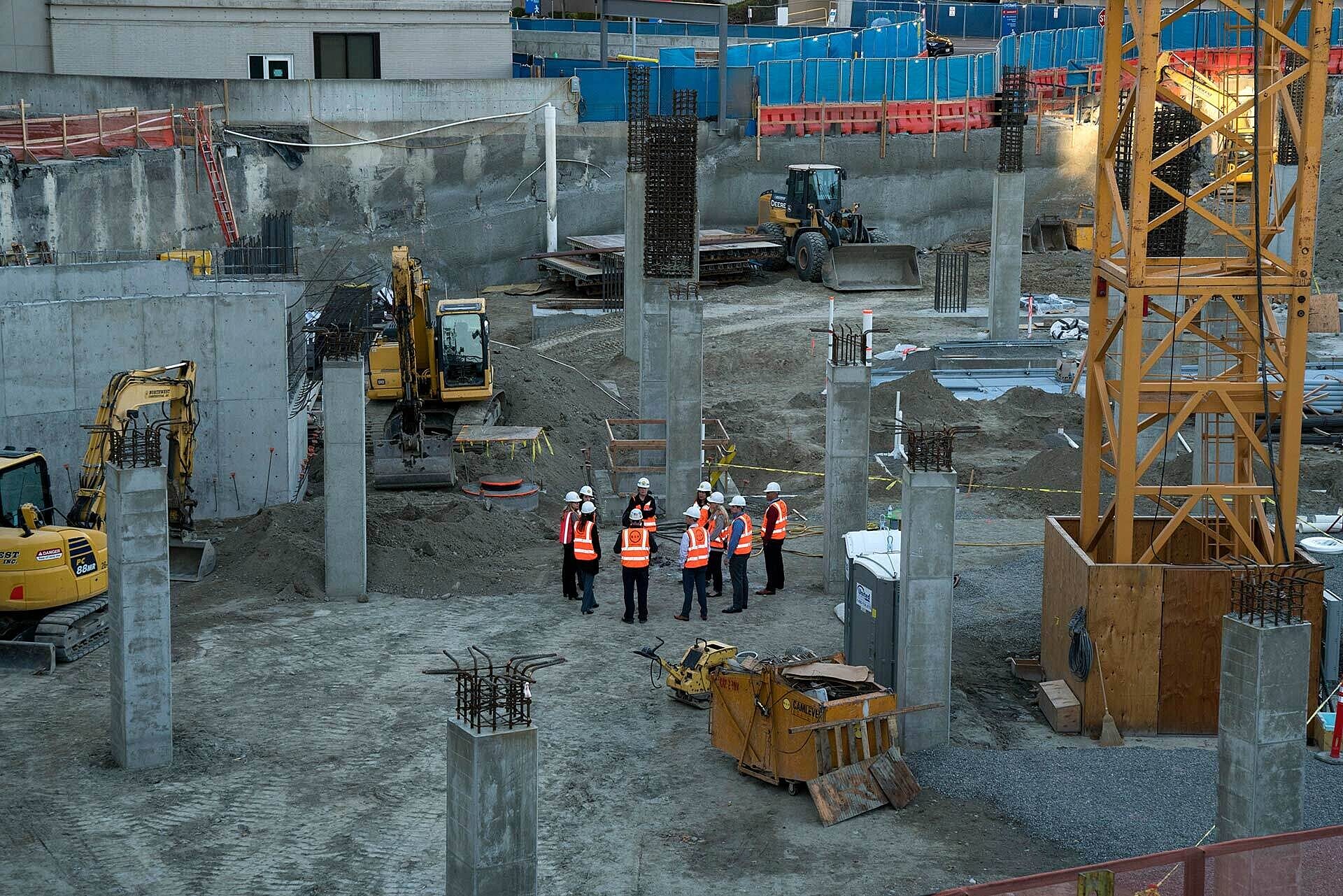 Clients and GC at jobsite with PPE