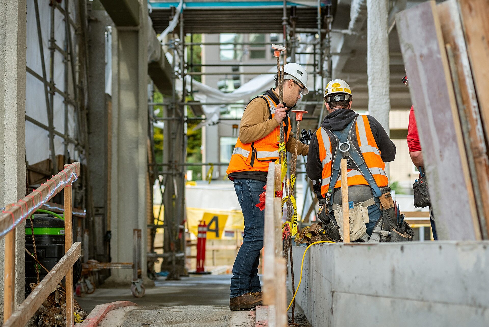 Photo of two construction workers conversing in jobsite