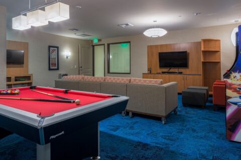 Media and lounge room with pool table at Homewood Suites by Hilton