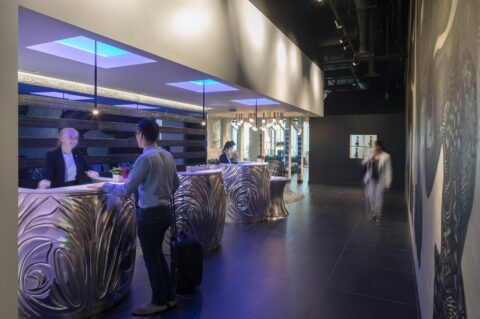 Reception and check-in area with freestanding metal desks at W Hotels Bellevue