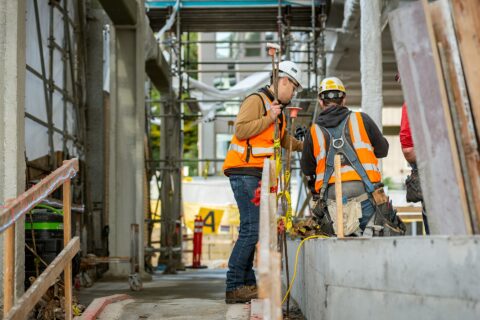 Photo of two construction workers conversing in jobsite