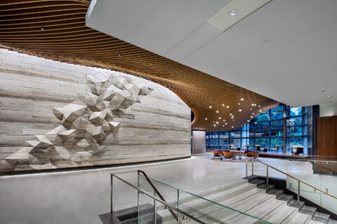 Interior of office building common area showing wall with 3D geographic rendition of mountain range