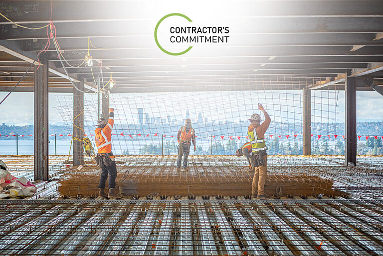 Contractor's Commitment logo on top of image with construction workers.