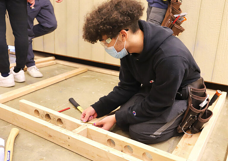 Student learning basic carpentry skills.
